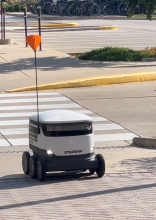 Purdue Starship robot on the sidewalk.